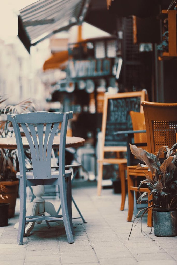 chairs-and-tables-in-restaurant-247931 Cozy outdoor cafe with vintage chairs and tables on a sunny street. Perfect spot to relax.